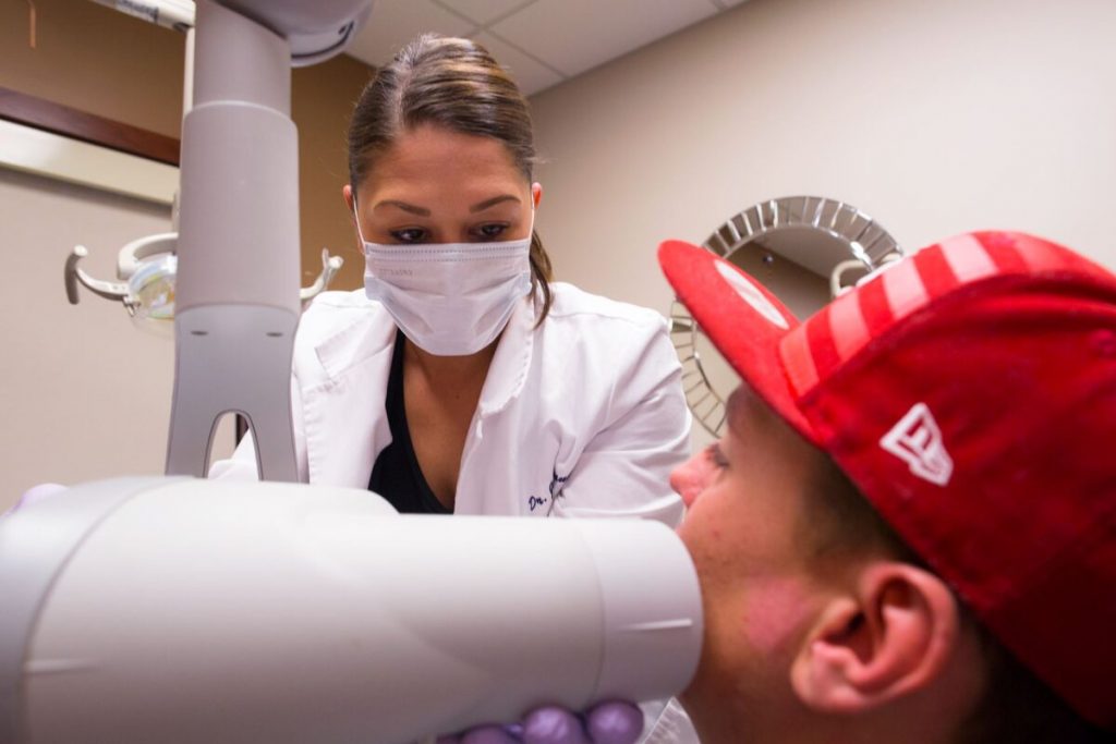 Dr-jessie-working-with-a-patient--Vaughn-Family-Dental-Best-Dentist-in-Independence-Missouri-MO