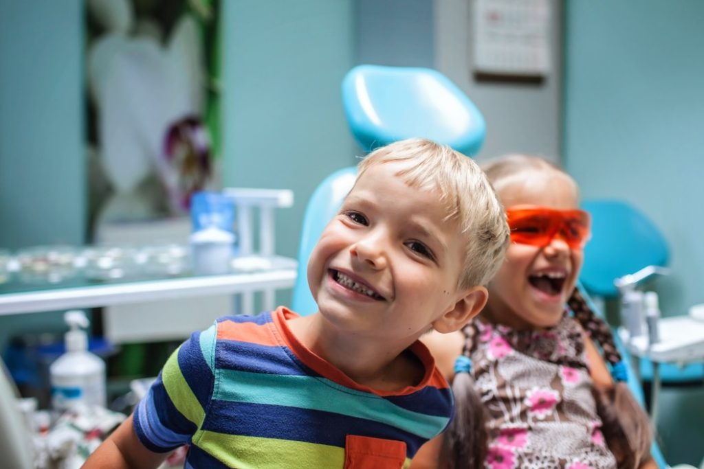 two-kids-having-fun-and-wearing-medical-eyeglasses-during-visit-to-dentist-office-office-teeth-oral-Vaughn-Family-Dental-Best-Dentist-in-Independence-Missouri-MO